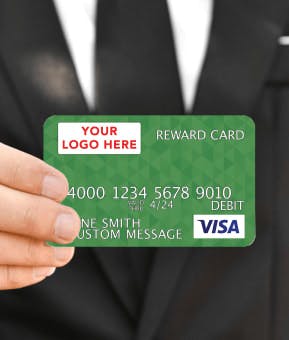 Man in suit holding Visa card
